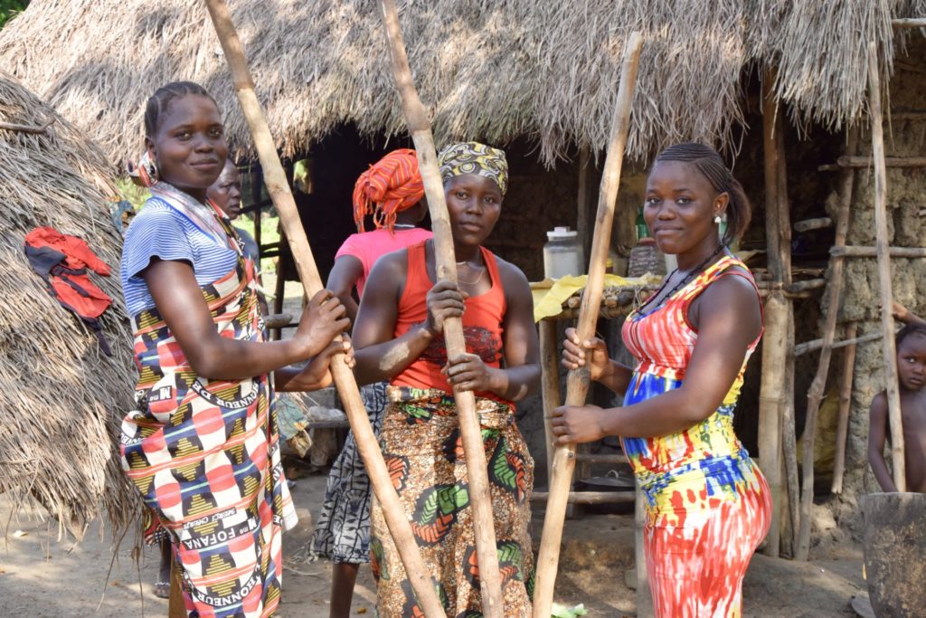 women in masakong village crushing palm fruit