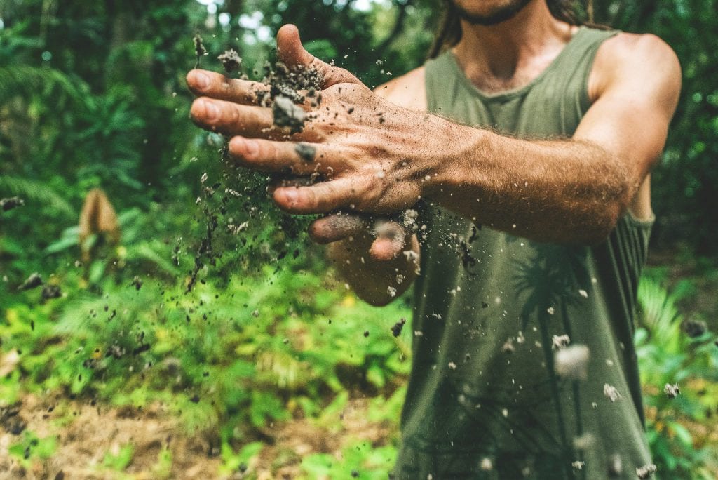 man with soil in hands