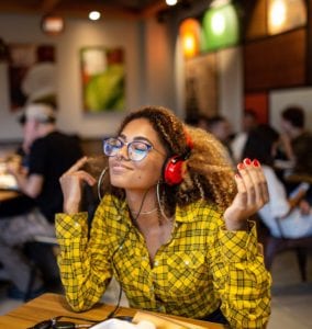 woman listening to music on red headphones