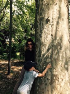 woman and boy hugging a tree