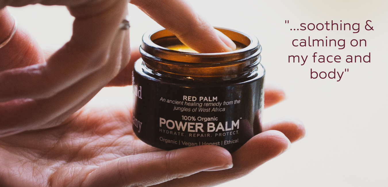 finger in pot of power balm