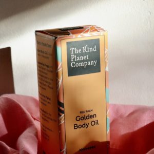 golden body oil box with pink fabric