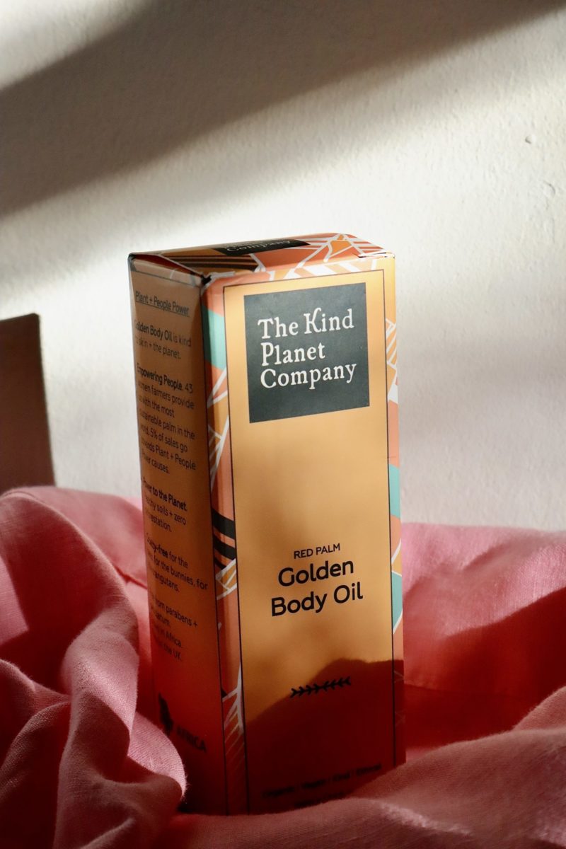 golden body oil box with pink fabric