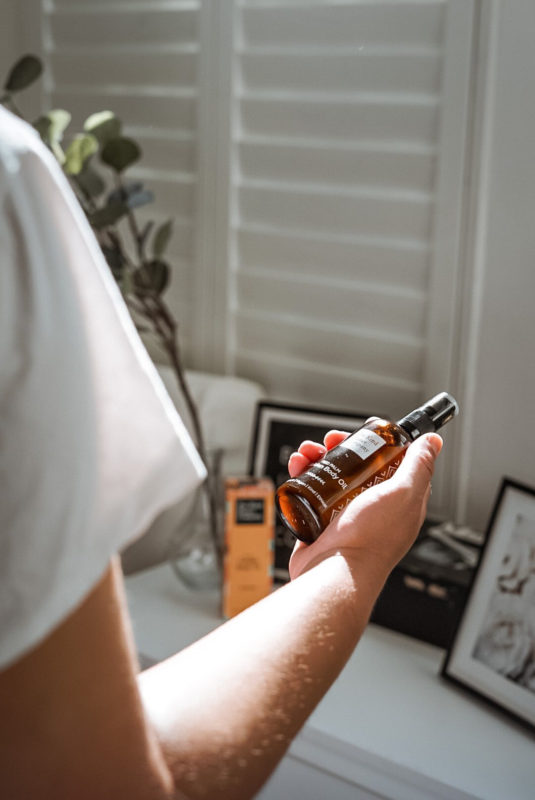 woman holding Golden Body Oil