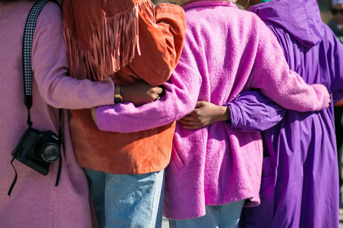 women with arms around each other