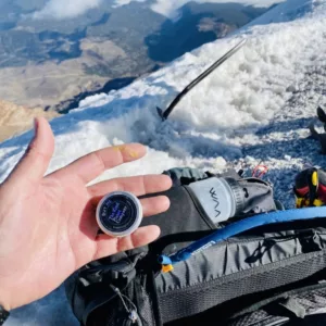 mini power balm held in hand on mountain